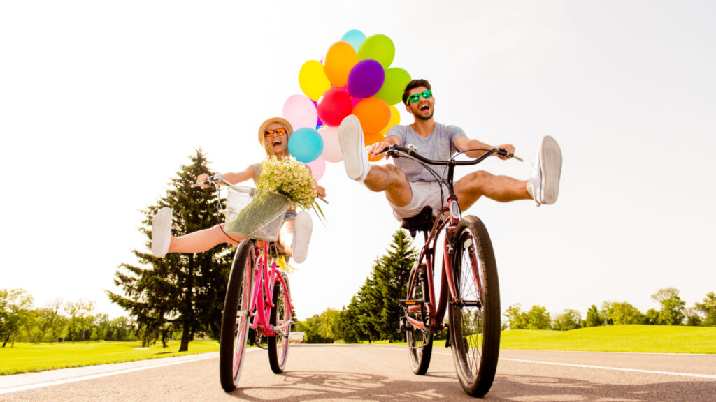 couple on bike with balloons crazy