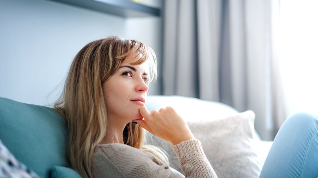 woman thinking wondering on couch