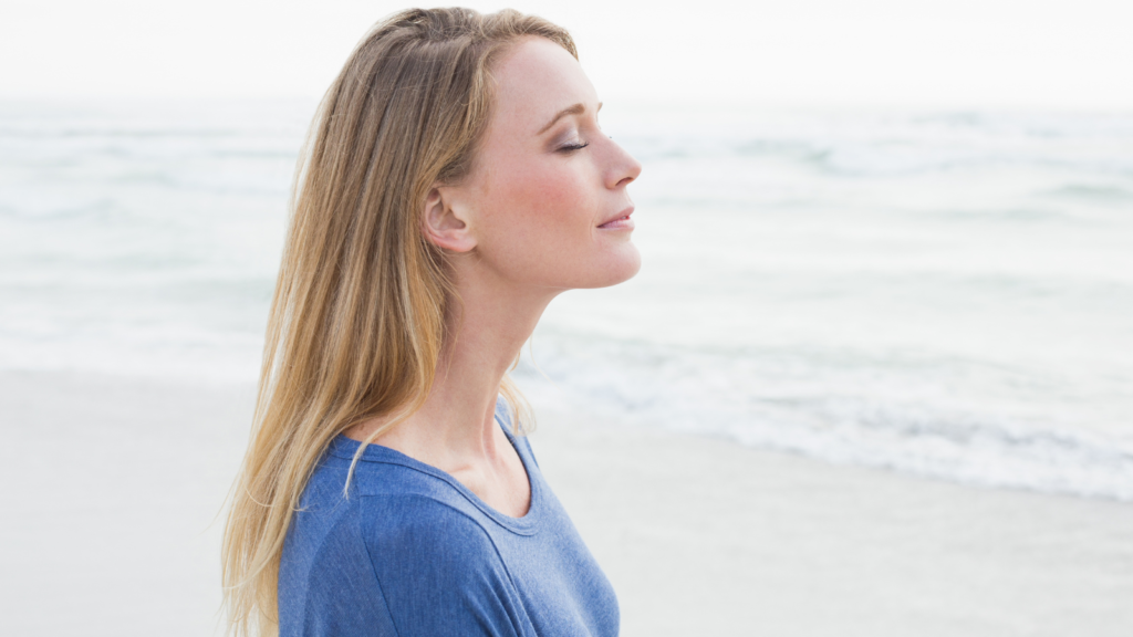 woman at peace breathing ocean happy content