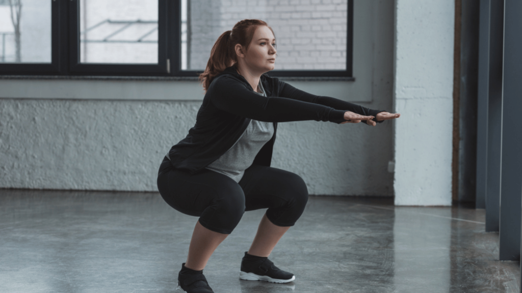 woman squatting workout strong