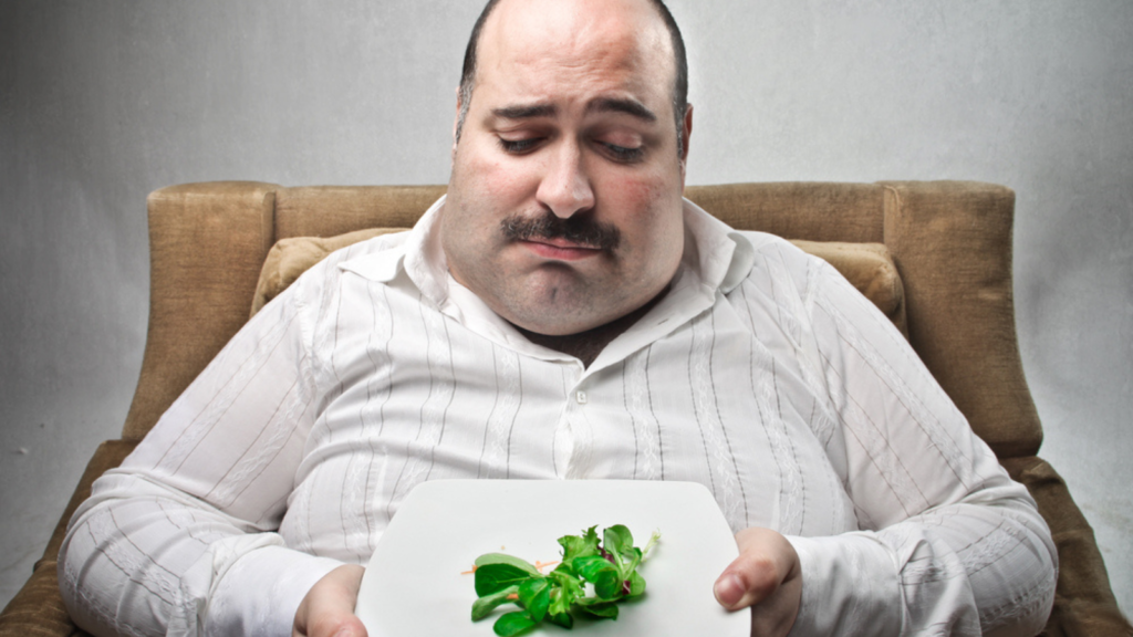 sad man eating a salad diet