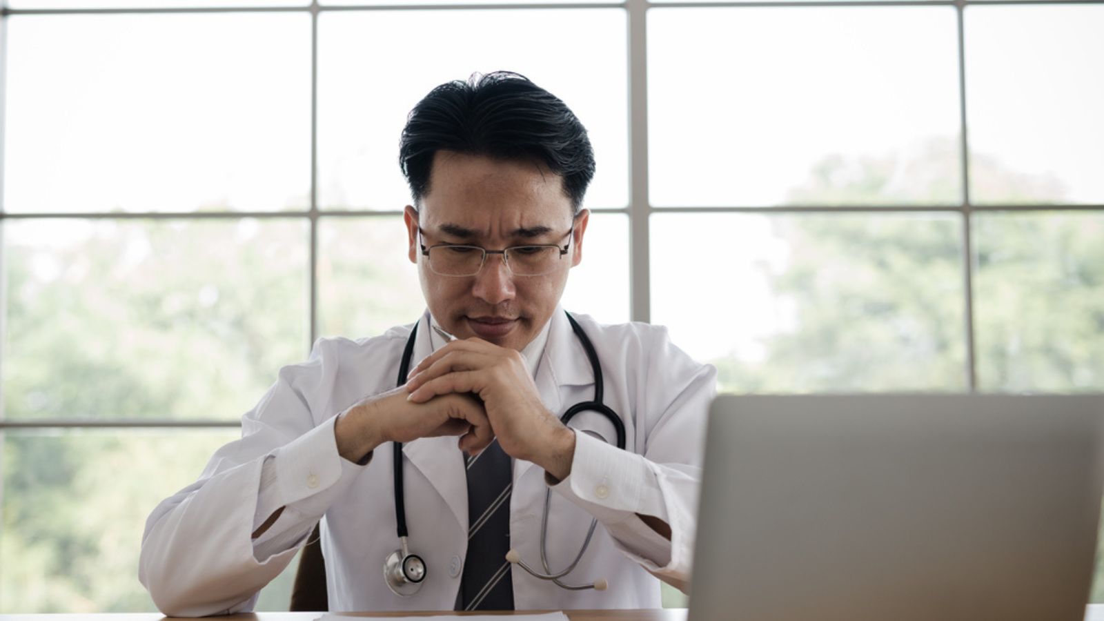 Worried Doctor sitting at his desk
