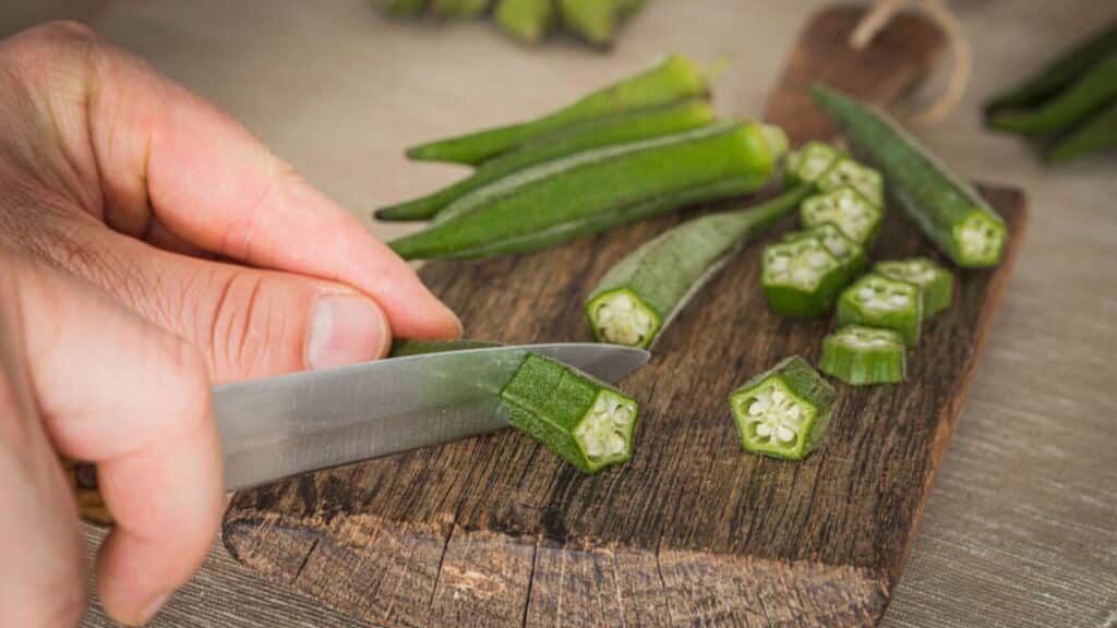 Okra. Vegetable on a kitchen board, partly chopped